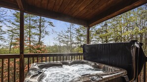 A hot tub on a wooden deck with a view of trees. - Inspiration Point 1 Bedroom 1 Bathroom Cabin (Sevierville)