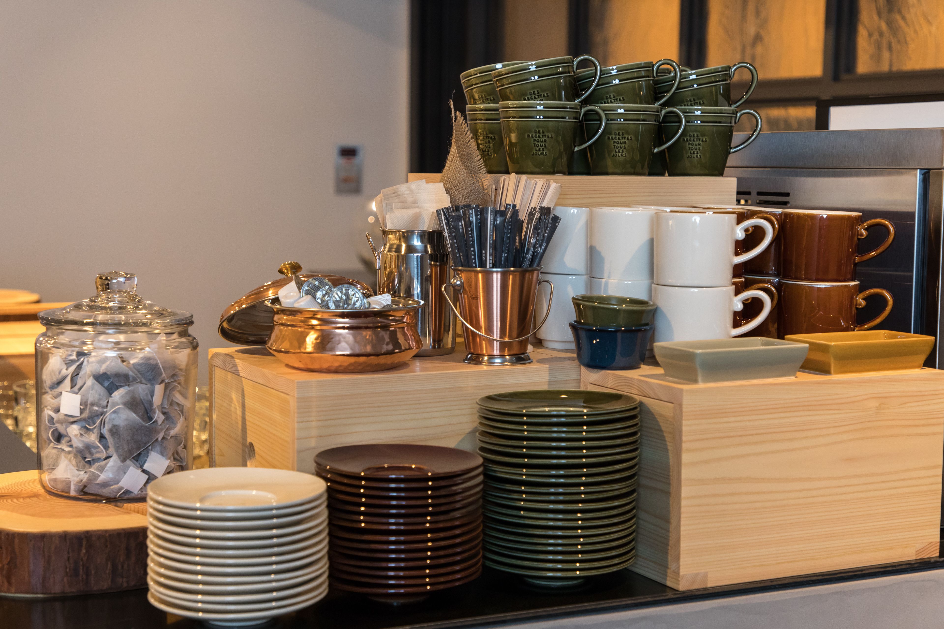 A buffet setup with various dishes and utensils.