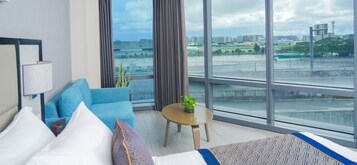 Runway Corner Suite with Airport View | Minibar, in-room safe, blackout drapes, free WiFi