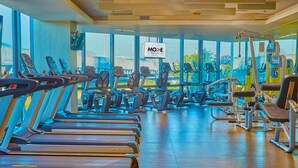 A gym with multiple treadmills, exercise bikes, and weight machines. - Savoy Hotel Manila near Airport NAIA Terminal 3 MNL (Pasay)