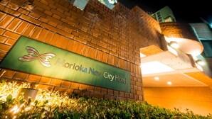 A brick wall with a sign for Moroka New City Hotel.