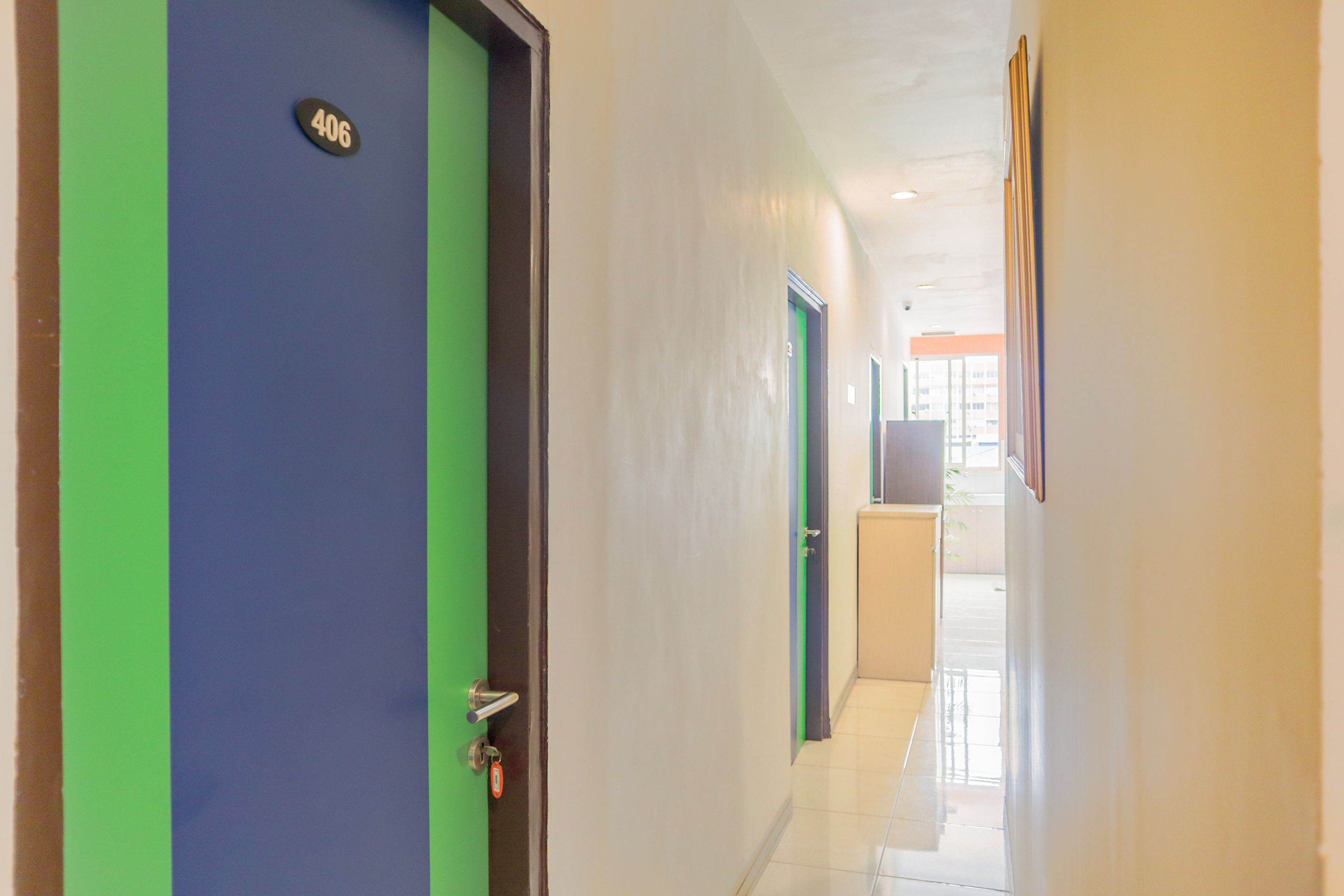 A hallway with doors numbered 406 and 3, leading to rooms.