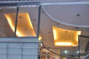 A modern interior with a curved staircase and illuminated panels.