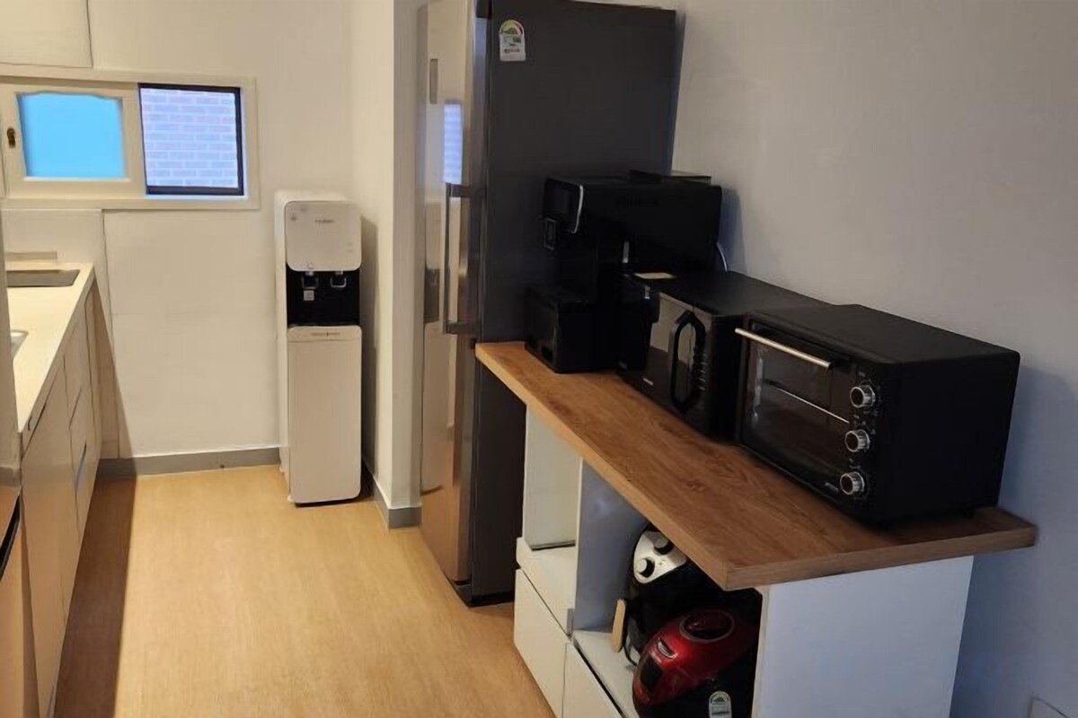 A compact kitchenette with a microwave, coffee maker, and a small refrigerator.