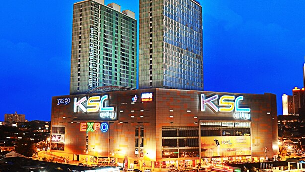 A KSC City building with a prominent sign, adjacent to a taller building with a 'Resort' sign. - Homestay in Johor - Secret Garden (Johor Bahru)