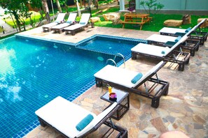 Outdoor pool, an infinity pool, pool umbrellas, pool loungers