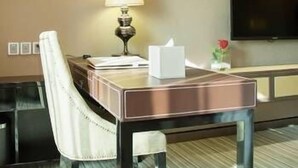 A hotel room with a desk, chair, lamp, television, and a framed picture on the wall. - Bahao Gongguan Hotel (Dongguan)