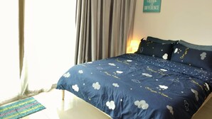 A bedroom with a bed, curtains, a wall sign, and a lamp. - HomeStay in Johor - Palazio (Johor Bahru)