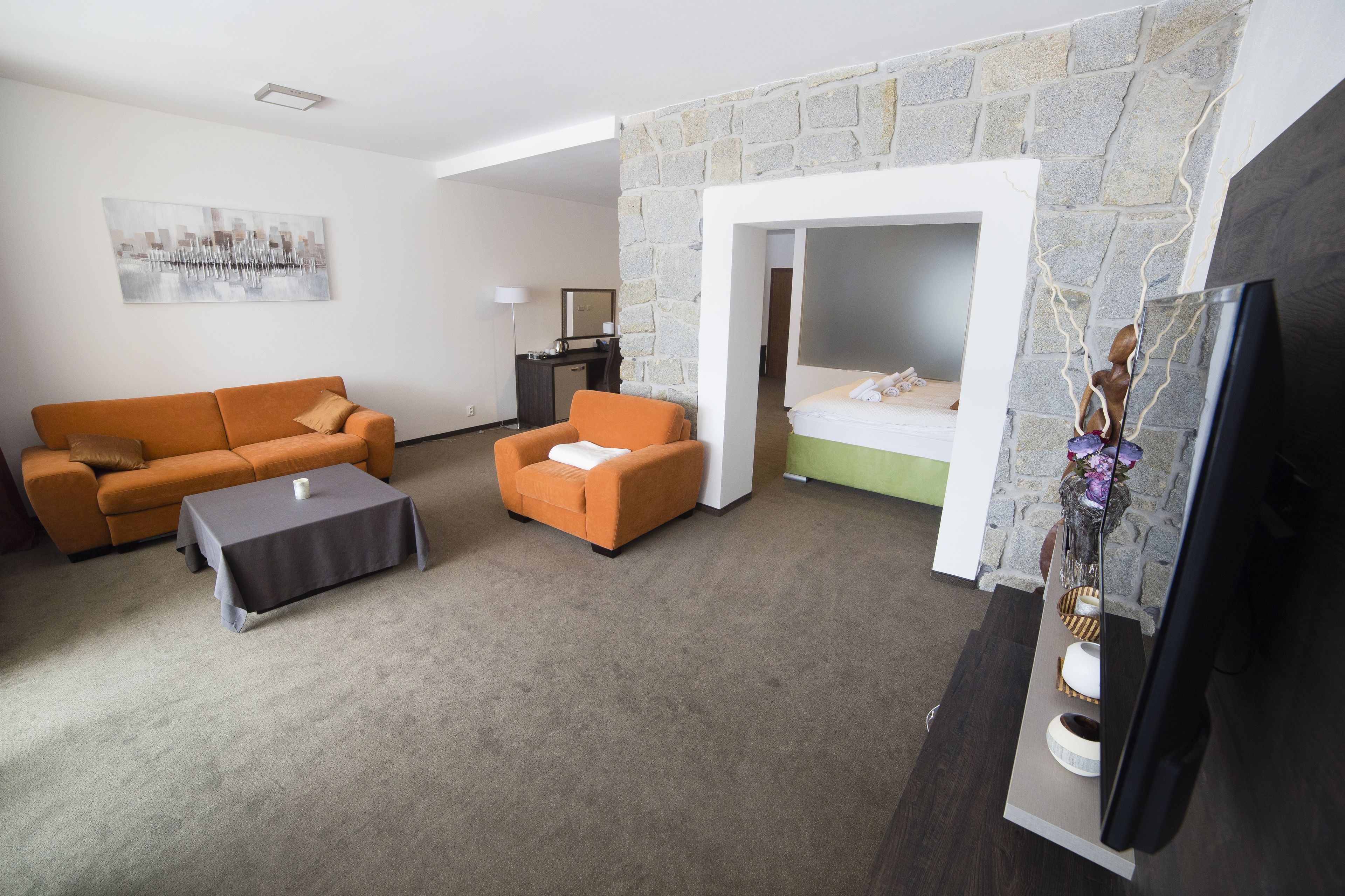suite, lake view | living area | flat-screen tv