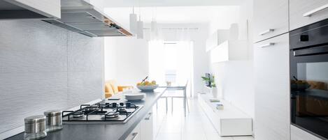 A modern kitchen with a central island, stainless steel appliances, and a bright, open layout.