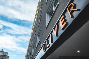 A building with a sign that reads "OLIVER" in large letters.