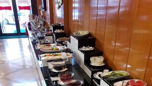 A buffet setup with various food items and condiments. - Spor Hotel (Ankara)