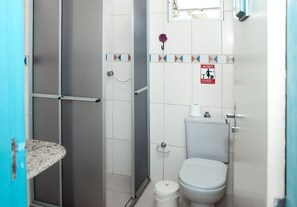 A bathroom with a shower, toilet, and sink.