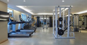 A modern gym with treadmills, weight machines, and cardio equipment. - Shama Lakeview Asoke Bangkok (Bangkok)