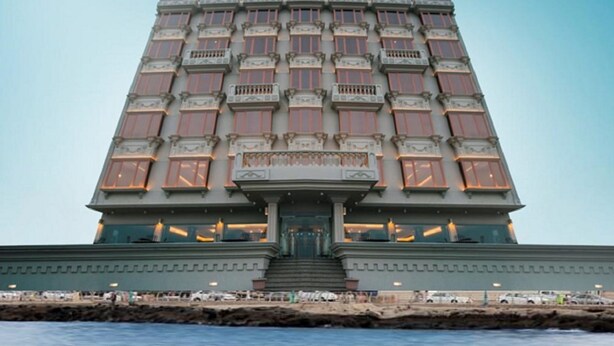 A tall, multi-story building with a symmetrical facade, large windows, and a central entrance with steps leading up to it. - Al-Borg Al-Watheer Serviced Apartments (Jizan)