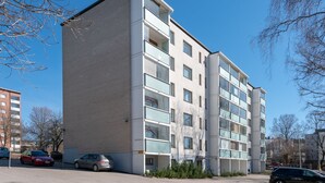 A multi-story residential building with a modern architectural style, featuring a flat roof and large windows. - Hiisi Homes Lohja (Lohja)