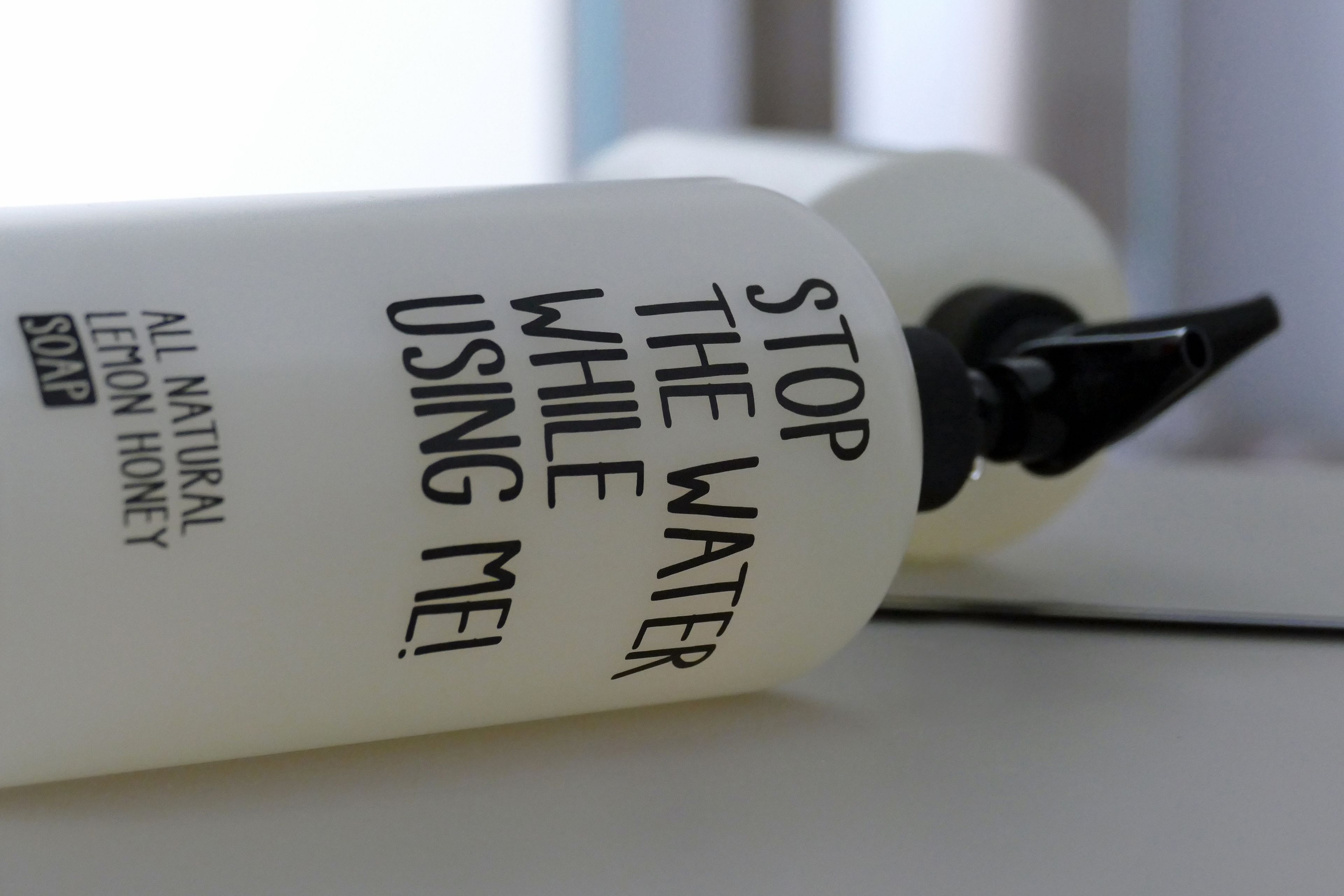 A bottle of soap with text on it.