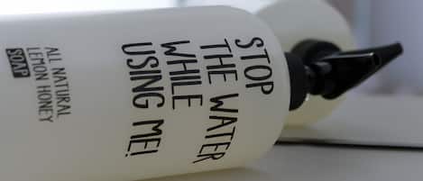 A bottle of soap with text on it.