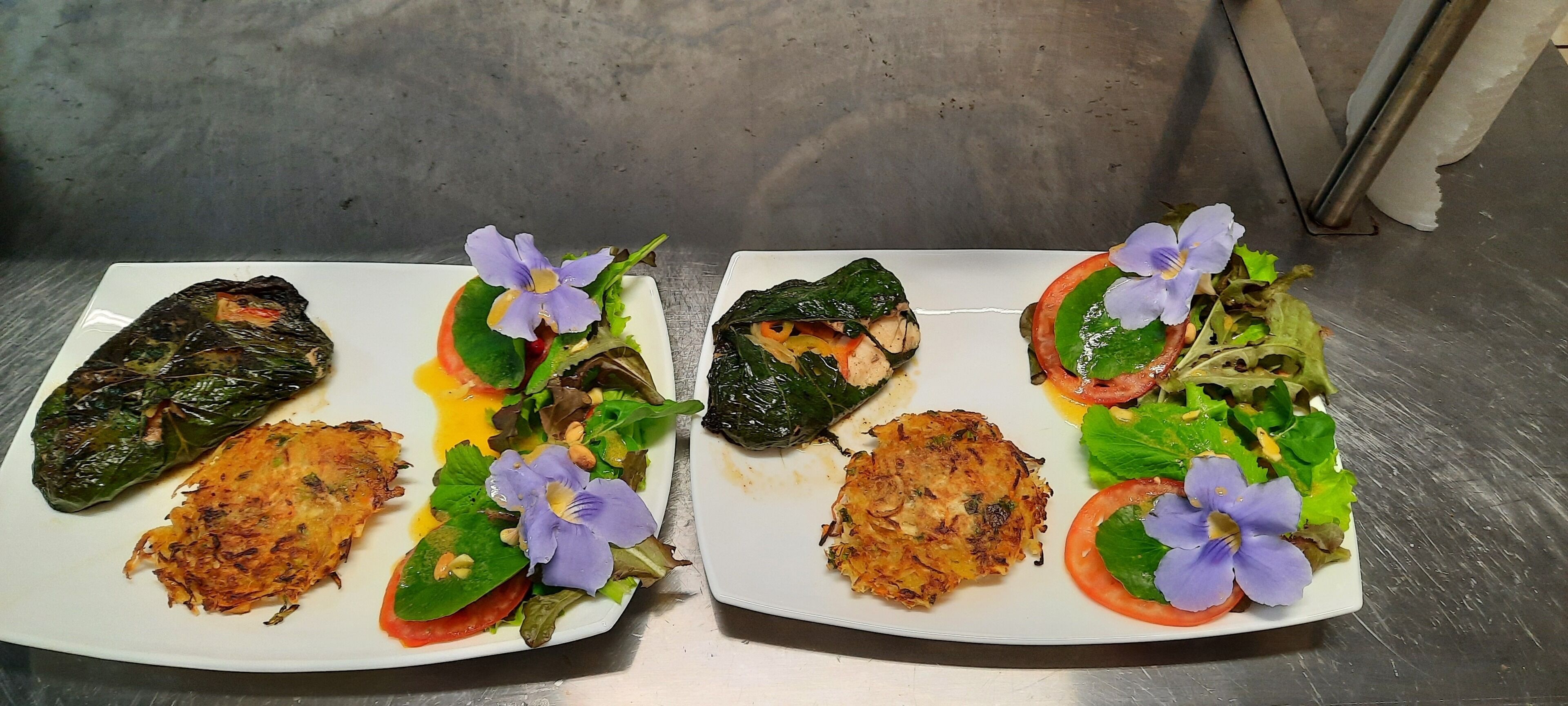 Dos platos de comida con verduras y flores.