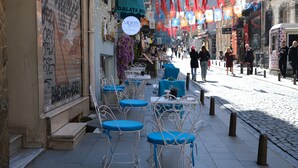 Outdoor seating with tables and chairs, a sign for 'Moon Galata Hotel', and a cobblestone street. - Galata Moon Hotel  (Istanbul)