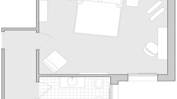 A floor plan with a central living area, two bedrooms, a bathroom, and a kitchen.