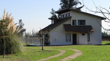 A modern two-story house with a visible garage, a covered porch, and a well-maintained lawn.