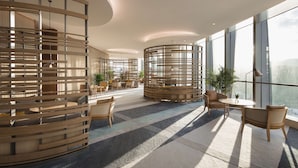 Un hall d’hôtel moderne avec des cloisons en bois, des sièges confortables et de grandes fenêtres offrant une vue dégagée.