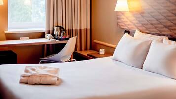 Premium bedding, pillow-top beds, desk, laptop workspace