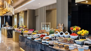 A buffet with a variety of food items and beverages.