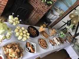A table with various food items including cupcakes, bread, and pastries.