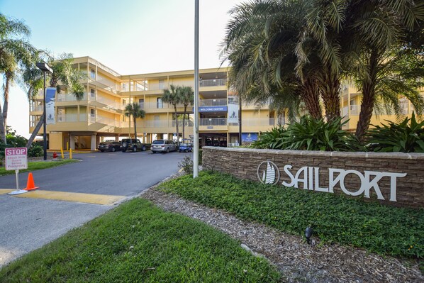 A multi-story hotel with a sign reading 'Sailport' and a 'Welcome Center' sign above the entrance.