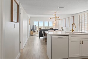 Enjoy cooking in this well-lit kitchen with a central island, dishwasher, and stainless steel sink.