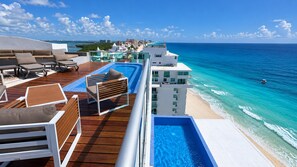 A cruise ship deck with a pool, sun loungers, and a view of the ocean. - There Can Be Only 1 Best Penthouse In all of Cancun!! (CANCUN)