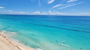 A beach with clear turquoise water and a sandy shore. - There Can Be Only 1 Best Penthouse In all of Cancun!! (CANCUN)