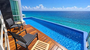 The Heated Main Level Infinity Pool is kept at a toasty 92 degrees. Beyond the pool is the roof, about 6 ft below the edge.