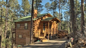 A log cabin with a porch, a staircase, and a driveway. - Ruidoso Log Cabin Retreat - Peaceful & Convenient (Ruidoso)