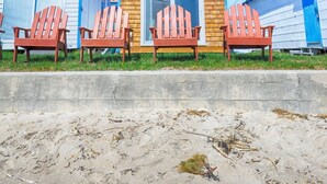 A beachside building with three red Adirondack chairs in front. - Moody Beach Front Studio Cottage WIFI (Wells)