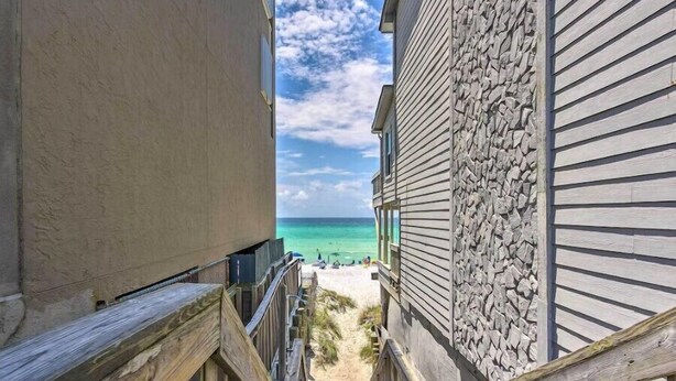 A narrow wooden staircase leading to a beach with a clear view of the ocean. - Spacious Rental, Three Story Townhome, Close to Pool (Miramar Beach)