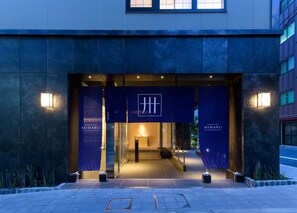 The entrance of the Mimaru Apartment Hotel with a modern design, featuring a prominent logo and illuminated signage. - MIMARU Tokyo Nihombashi Suitengumae (Tokyo)
