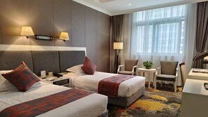 A hotel room with two beds, a desk, a chair, and a large window. - Kunshan Yuxing Hotel (Suzhou)