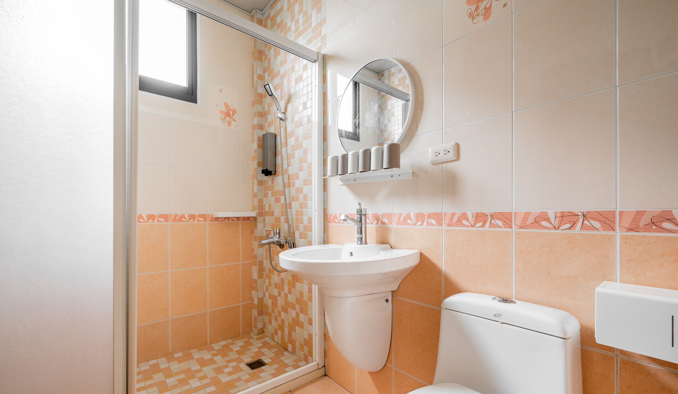 A bathroom with a shower, sink, and toilet.
