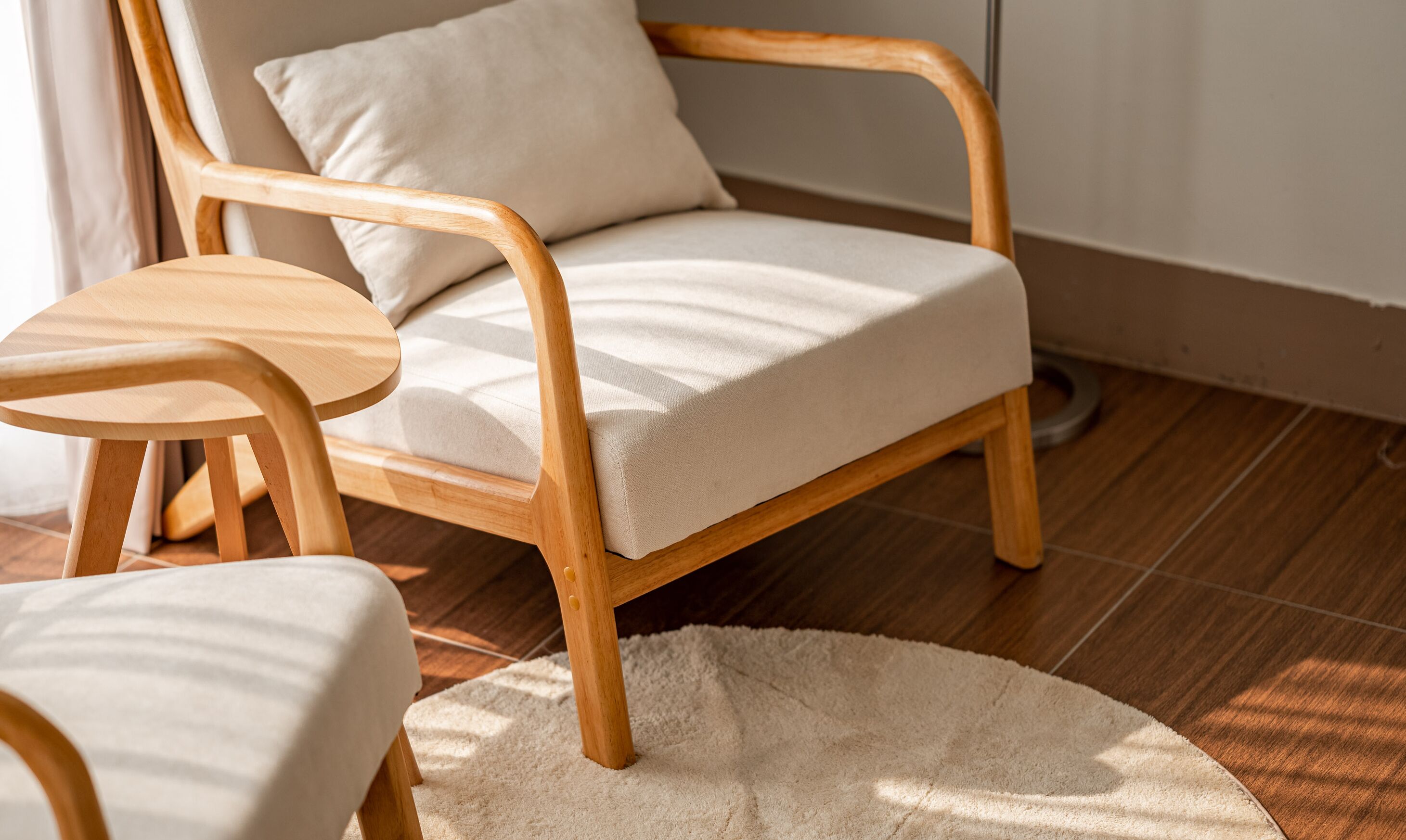 A wooden chair with a cushion and a small wooden table.