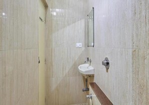A bathroom with a sink, mirror, and tiled walls.