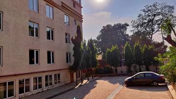 A building with multiple windows and a car parked in front.