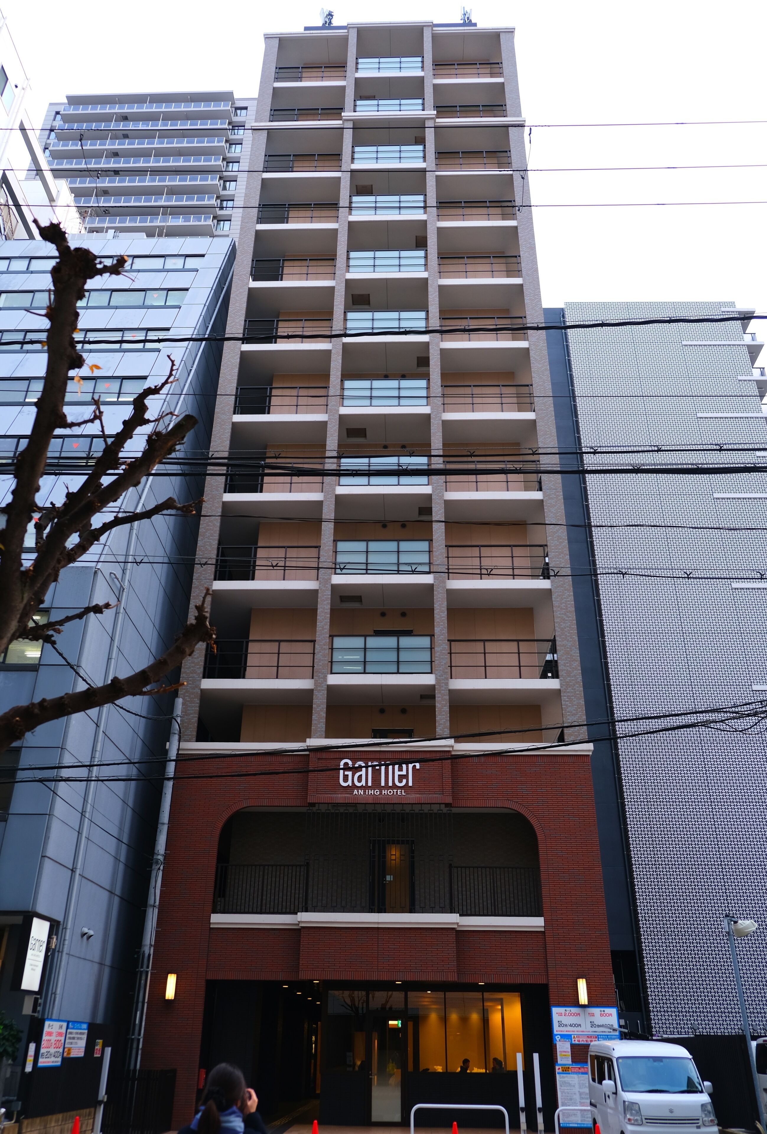 A multi-story hotel with a modern facade, balconies on each floor, and a sign indicating it is an 'An Inn Hotel'.