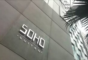 A building with a sign that reads "SOHO SUITES".