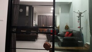 A modern living room with a sofa, a coffee table, and a dining area in the background. - New Loft Modern Home (Hang Dong)