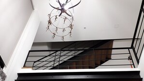 A modern staircase with a wooden finish and metal railings, leading to an upper floor. - New Loft Modern Home (Hang Dong)