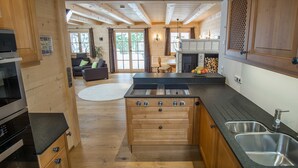 A wooden interior with a kitchen, dining area, and living room.