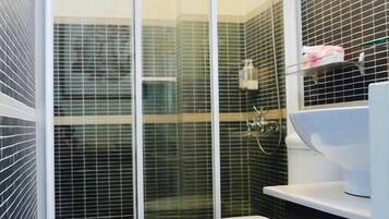Shower, designer toiletries, hair dryer, slippers